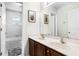Bright bathroom with a double vanity, marble countertops, and white tile accents at 1907 Lakeview Way, Kissimmee, FL 34759