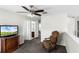 Upstairs bedroom with decorative chair, TV and doorway to the en suite bath at 1907 Lakeview Way, Kissimmee, FL 34759