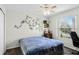 Inviting bedroom featuring carpeted floors, neutral paint, a window, and a ceiling fan at 1907 Lakeview Way, Kissimmee, FL 34759
