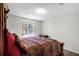 Cozy bedroom with a decorative quilt, soft lighting, and a relaxing atmosphere at 1907 Lakeview Way, Kissimmee, FL 34759