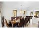 Elegant dining room with a large table, ornate chairs, and view into the living room at 1907 Lakeview Way, Kissimmee, FL 34759