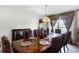 Beautiful dining room with ornate wooden table, decorative chairs, and window views at 1907 Lakeview Way, Kissimmee, FL 34759