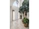 Bright foyer featuring tile flooring, a decorative palm, and a soaring window above the front door at 1907 Lakeview Way, Kissimmee, FL 34759