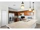 Bright kitchen with stainless steel refrigerator, modern appliances, and island at 1907 Lakeview Way, Kissimmee, FL 34759