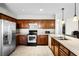 Spacious kitchen featuring wood cabinetry and stainless steel appliances at 1907 Lakeview Way, Kissimmee, FL 34759
