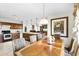 Bright kitchen with stainless steel appliances, wood cabinets, and open dining area at 1907 Lakeview Way, Kissimmee, FL 34759