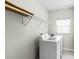 Bright laundry room featuring a modern washer and dryer and ample shelf space for storage at 1907 Lakeview Way, Kissimmee, FL 34759