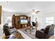 Large living room with a built-in entertainment center, cozy seating, and natural light at 1907 Lakeview Way, Kissimmee, FL 34759
