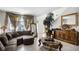 Comfortable living room with decorative curtains, a large sectional sofa, and an entryway at 1907 Lakeview Way, Kissimmee, FL 34759