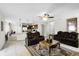 Open-concept living room featuring tile floors, ceiling fan, and open access to the kitchen at 1907 Lakeview Way, Kissimmee, FL 34759