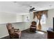 Cozy loft area with comfortable seating, soft carpet, and natural light from the window at 1907 Lakeview Way, Kissimmee, FL 34759