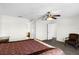 Bright main bedroom featuring neutral paint, ceiling fan, carpet, and an ensuite bathroom at 1907 Lakeview Way, Kissimmee, FL 34759
