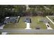 Expansive aerial view shows a well-manicured lawn and showcases the home's lovely neighborhood setting at 350 Marion Oaks Pass, Ocala, FL 34473