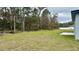 Large backyard with lush green grass, mature trees, and space for outdoor activities at 350 Marion Oaks Pass, Ocala, FL 34473