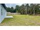 Spacious backyard featuring a wooden fence and concrete patio at 350 Marion Oaks Pass, Ocala, FL 34473