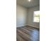 Bright bedroom with wood-look flooring and a window providing natural light at 350 Marion Oaks Pass, Ocala, FL 34473
