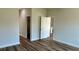 Bright bedroom with wood-look floors and two doorways at 350 Marion Oaks Pass, Ocala, FL 34473