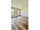 Spacious bedroom with wood-look flooring and plenty of natural light from multiple windows at 350 Marion Oaks Pass, Ocala, FL 34473