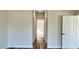 Hallway with a wood look floor and three doors at 350 Marion Oaks Pass, Ocala, FL 34473