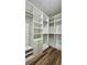 This walk-in closet features custom white shelving, drawers, and clothing rods for optimal storage organization at 350 Marion Oaks Pass, Ocala, FL 34473