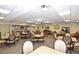 Community room with tables, chairs, and kitchen at 400 E Colonial Dr # 207, Orlando, FL 32803