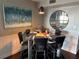 Modern dining area with glass table and four black chairs at 400 E Colonial Dr # 207, Orlando, FL 32803