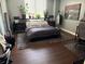 Spacious main bedroom with dark wood flooring and large artwork at 400 E Colonial Dr # 207, Orlando, FL 32803