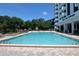 Inviting swimming pool with surrounding lounge chairs at 400 E Colonial Dr # 207, Orlando, FL 32803