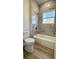 Full bathroom featuring a bathtub, gray tile, window and tile flooring at 559 Marion Oaks Blvd, Ocala, FL 34473