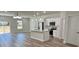 Well-lit kitchen with stainless steel appliances, white cabinets and island with a stainless steel faucet at 559 Marion Oaks Blvd, Ocala, FL 34473