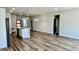 Open-concept living room with wood flooring and an island featuring modern pendant lighting at 559 Marion Oaks Blvd, Ocala, FL 34473