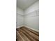 Walk-in closet with wire shelving and wood-look flooring at 559 Marion Oaks Blvd, Ocala, FL 34473