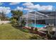 Beautifully landscaped backyard with a refreshing screened pool and plenty of space for outdoor enjoyment at 8048 Canyon Lake Cir, Orlando, FL 32835