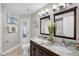 Bathroom featuring a double bowl sink, a granite countertop, and a large double mirror at 8048 Canyon Lake Cir, Orlando, FL 32835
