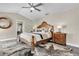 Comfortable primary bedroom featuring a wood bed frame, vaulted ceiling, and black and white carpet at 8048 Canyon Lake Cir, Orlando, FL 32835