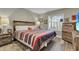 Bedroom featuring a wood bed frame, bedside tables, and a rustic dresser with a TV on top at 8048 Canyon Lake Cir, Orlando, FL 32835
