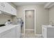 Bright and clean laundry room featuring a washer, dryer, laundry sink, and cabinets for storage at 8048 Canyon Lake Cir, Orlando, FL 32835
