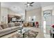 Open-concept living room with neutral tones, comfortable seating, and seamless flow to the kitchen and foyer at 8048 Canyon Lake Cir, Orlando, FL 32835