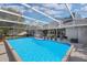 Inviting screened pool area with an outdoor kitchen, dining space, and comfortable lounge chairs at 8048 Canyon Lake Cir, Orlando, FL 32835