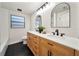Bathroom featuring double vanity with quartz countertops and modern fixtures at 133 Pinecrest Dr, Sanford, FL 32773