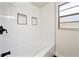 A bathtub and white tile in a bathroom at 133 Pinecrest Dr, Sanford, FL 32773