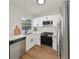 Updated kitchen featuring stainless steel appliances, white cabinetry and quartz countertops at 133 Pinecrest Dr, Sanford, FL 32773
