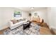 Bright living room featuring hardwood floors, a sofa, and an accent rug at 133 Pinecrest Dr, Sanford, FL 32773