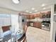 Bright kitchen featuring stainless steel appliances, granite countertops, and an adjacent dining area at 1918 Conway Rd # 3, Orlando, FL 32812