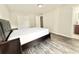 Comfortable main bedroom with wood-look vinyl flooring, an ensuite bathroom, and closet with double doors at 1918 Conway Rd # 3, Orlando, FL 32812