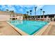 Large community pool with blue water and surrounding brick patio near townhouses at 1918 Conway Rd # 3, Orlando, FL 32812