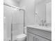 Bathroom featuring shower with glass door, gray vanity, and toilet at 2990 Arranmore Dr, Ormond Beach, FL 32174