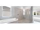 Well-lit bathroom with soaking tub and separate shower with glass door at 2990 Arranmore Dr, Ormond Beach, FL 32174