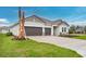 Beautiful home exterior with a wide driveway and well-kept lawn at 2990 Arranmore Dr, Ormond Beach, FL 32174