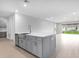 Spacious kitchen featuring gray cabinets, a center island, and stainless steel dishwasher at 2990 Arranmore Dr, Ormond Beach, FL 32174